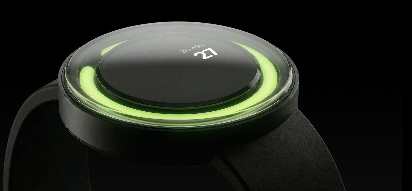 The EQUA bracelet from the side: a green ring of light glowing under the glass bevel, the face reading 30 min, 27